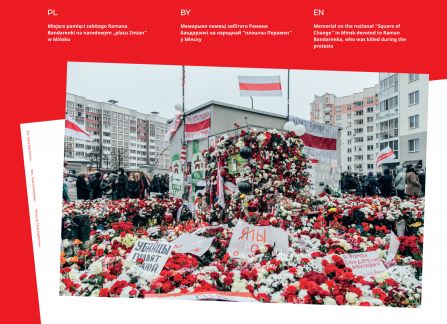 Photograph from the exhibition Belarus. road to freedom. the memorial site of the killed Roman bandarenko in the square of changes in Minsk. white and red flowers, in the background a crowd of people, high blocks of flats.